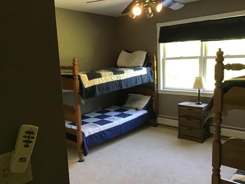 a bedroom with two bunk beds and a window at WELCOME Hikers, Bikers, boaters n trailers etc plenty of PRIVATE parking in Wilmington