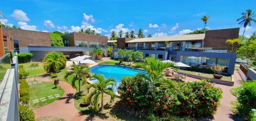 an aerial view of a resort with a swimming pool at Imbassaí Apartments in Imbassai