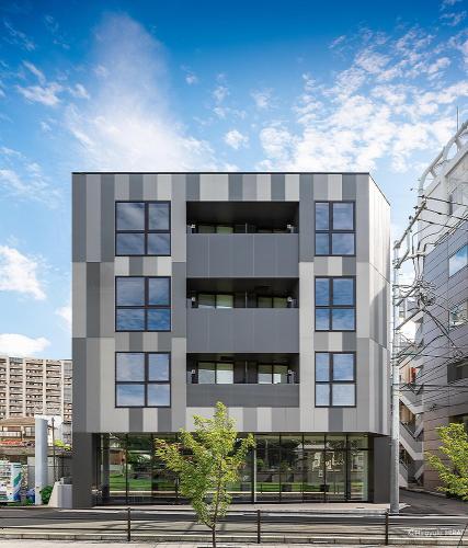 a tall gray building in a city at THE VIEW Odawara shiro-no mieru hotel - Vacation STAY 66140v in Odawara