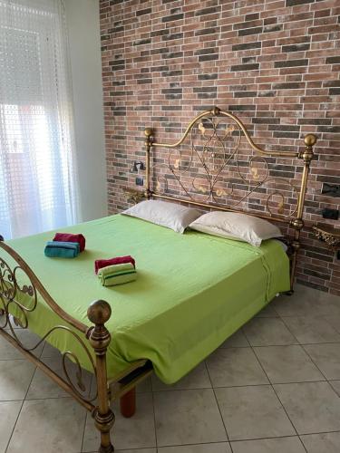 a bed in a room with a brick wall at Casa Vacanze dell'aviatore in Alghero