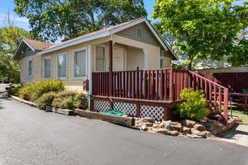 a small house with a red deck in front at Skylark Shores Resort in Lakeport