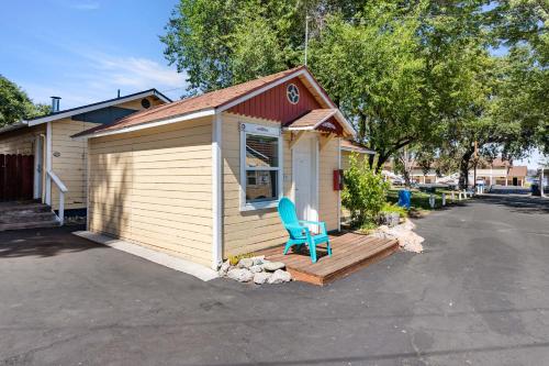 a small building with a blue chair on a deck at Skylark Shores Resort in Lakeport