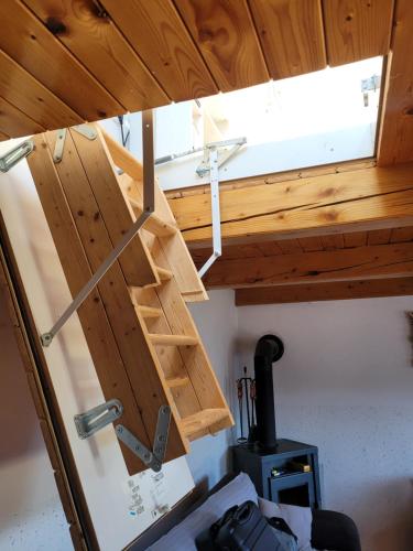 a wooden door in a room with a stove at Farm ,zidanica ,JOLI in Gorica pri Slivnici