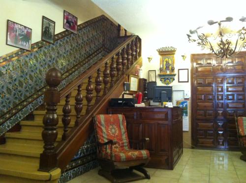 a staircase in a room with a chair and a desk at Hostal Paracuellos in Paracuellos de Jarama