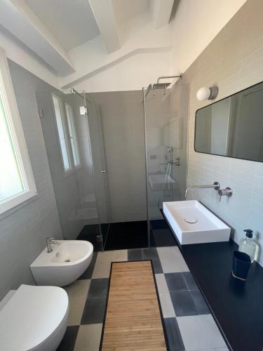 a bathroom with a toilet and a sink at Casa Don Michele in Letojanni