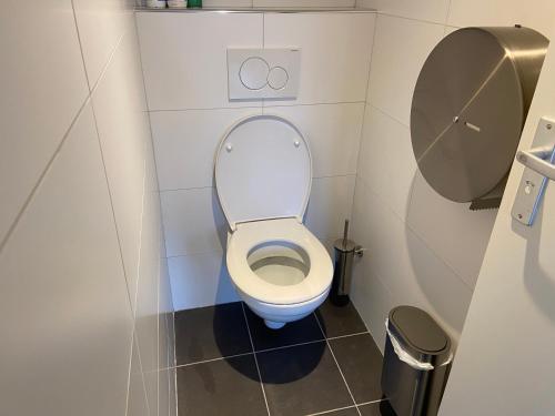 a small bathroom with a toilet in a stall at Xplore Hostel Amsterdam in Amsterdam