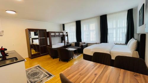 a bedroom with a bed and a living room at Akomo Bern in Bern