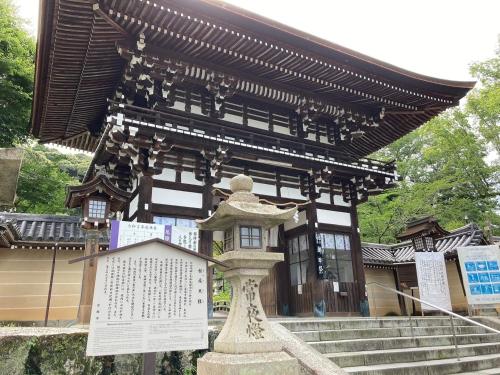 a building with a statue in front of it at HOTEL TAVINOS Kyoto in Kyoto