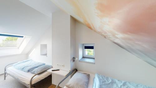 a room with two beds and a window at Ferienhof A&B Wellness Villa 12 personen in Bullange