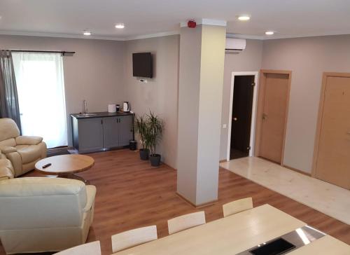 a living room with a couch and a table at Kuivižu Krogs - motelis in Salacgrīva