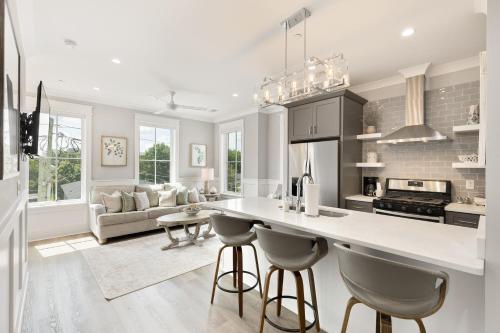 a kitchen and living room with a counter and chairs at The Magnolia Suite at 124 Spring in Charleston