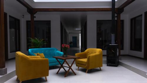 a living room with two chairs and a table at REEC Latacunga by Oro Verde Hotels in Latacunga