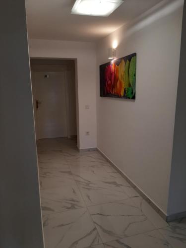 a hallway with a painting on the wall at Petra Rooms and Apartments in Rab