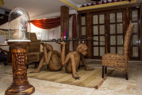 a group of monkey statues sitting on the floor in a room at Casa Jaguar Hotel & Boutique in Acapulco