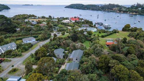 an aerial view of a house on the shore of a lake at Kaka Retreat Motel, Stewart Island in Half-moon Bay