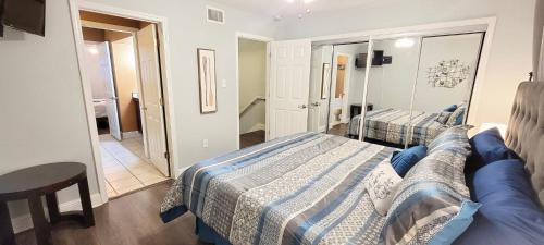 a bedroom with two beds and a blue couch at Seaside Gem in Biloxi