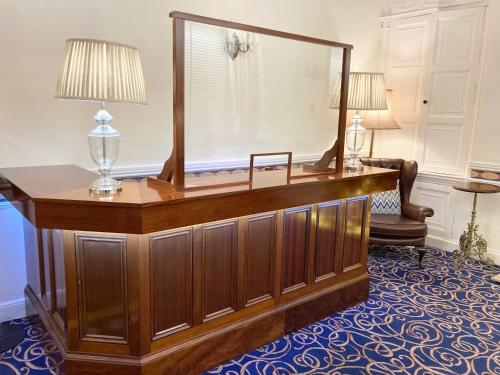 a dressing table with a mirror in a room at Dergvale Hotel in Dublin