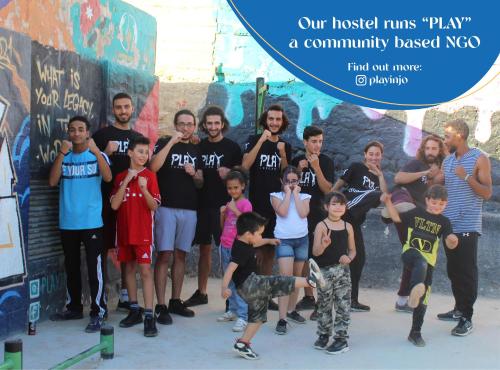 a group of people standing in front of a wall at Battuta Hostel in Amman