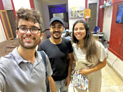 two men and a woman posing for a picture at One Season Hotel in Cairo