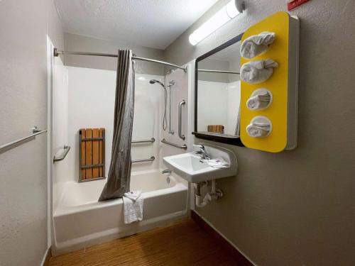 a bathroom with a sink and a tub and a shower at Motel 6-Camp Springs, DC - South Camp Springs in Camp Springs