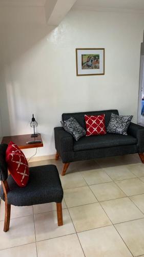 a living room with a couch and a chair at Departamentos Rodrigo in Posadas