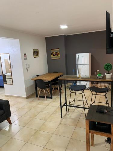 a living room with two tables and a refrigerator at Departamentos Rodrigo in Posadas