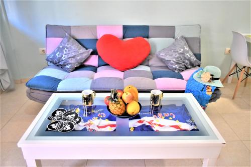 a living room with a couch and a table with food at Apartment Paraiso in Guargacho