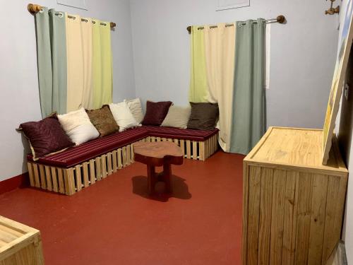 a living room with a couch and a stool at Pazuri Hostel in Moshi