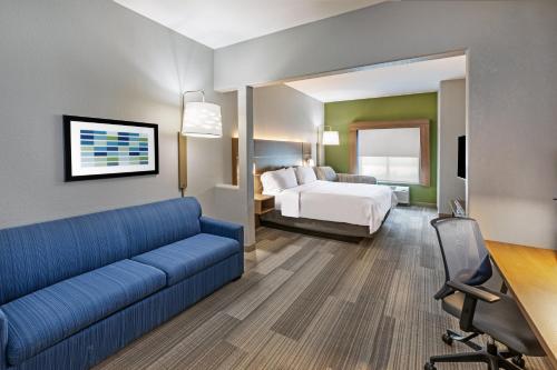 a hotel room with a couch and a bed at Holiday Inn Express Hotel & Suites Austin NE-Hutto by IHG in Hutto