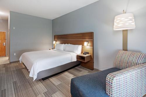 a hotel room with a bed and a couch at Holiday Inn Express Hotel & Suites Austin NE-Hutto by IHG in Hutto