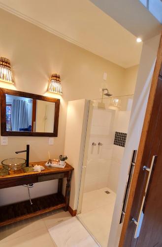 a bathroom with a shower and a sink at Pousada Paraíso Gaia in Praia do Rosa