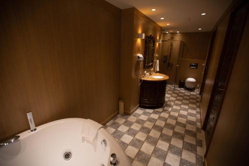 a large bathroom with a tub and a sink at Songdo Central Park Hotel in Incheon