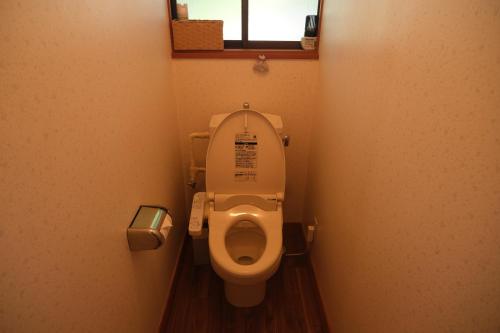 a small bathroom with a toilet in a stall at フォレストコテージ奥州 in Oshu