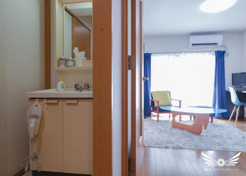 a kitchen and a dining room with a table at Minoshima Apartment 401 in Fukuoka