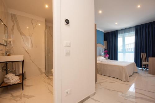 a hotel room with a bed and a bathroom at Hotel Marconi Express in Bologna