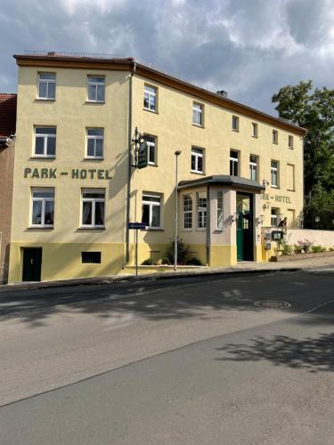 a large building on the corner of a street at Parkhotel Schnorr in Lutherstadt Eisleben