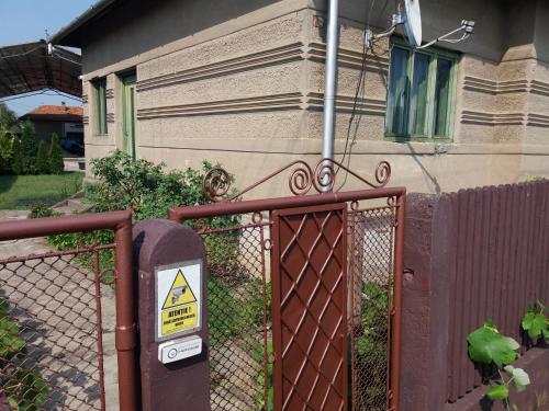 a fence in front of a house with a warning sign at DOBRA GAZDA - transit sleep in Dobra