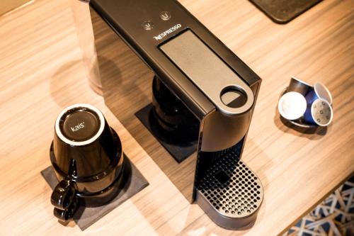a coffee maker sitting on a table with a coffee mug at Lapland Hotels Sky Ounasvaara in Rovaniemi