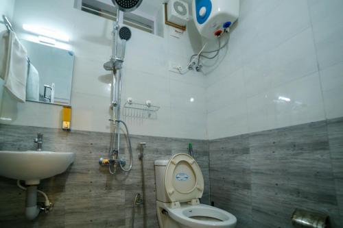 a bathroom with a toilet and a sink at Belljem Homes -your own private resort -6 BHK S in Trichūr