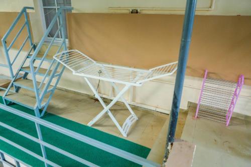 a shelf and two chairs in a room at Belljem Homes -your own private resort -6 BHK S in Trichūr