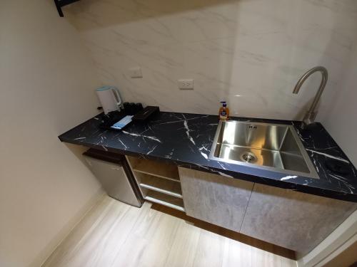 a kitchen with a sink and a counter top at 航空棧輕旅民宿 in Huxi