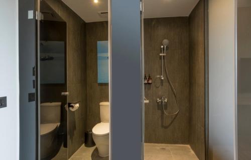 a bathroom with a shower and a toilet and a sink at Hotelday Sun Moon Lake in Yuchi