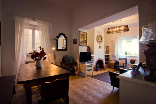 a living room with a table and a living room with a fireplace at Cascais Boutique Hostel in Cascais