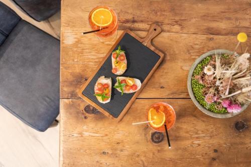 a table with plates of food and a bowl of food at HEIMAT living like a local in Silandro