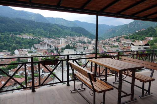 a table and chairs on a balcony with a view at Борник Хил / Bornik Hill in Devin