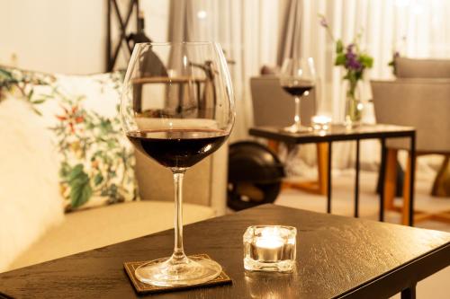 two glasses of red wine sitting on a table at Villa Sokol in Borovets