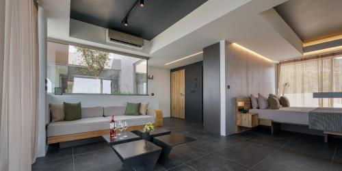 a living room with a couch and a table at 3 Olive Trees in Anavissos