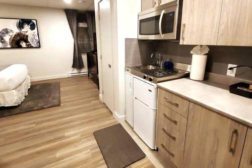 a small kitchen with a sink and a microwave at Cozy Sweet Studio #5, Only 10 min to D.T. Ottawa in Gatineau