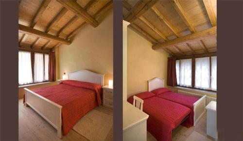 2 Betten in einem Zimmer mit roter Bettwäsche und Fenstern in der Unterkunft Villa Avesani in Pastrengo
