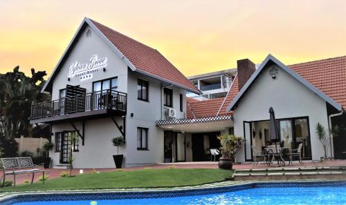 a house with a pool in front of it at Sylvan Grove Guest House in Durban